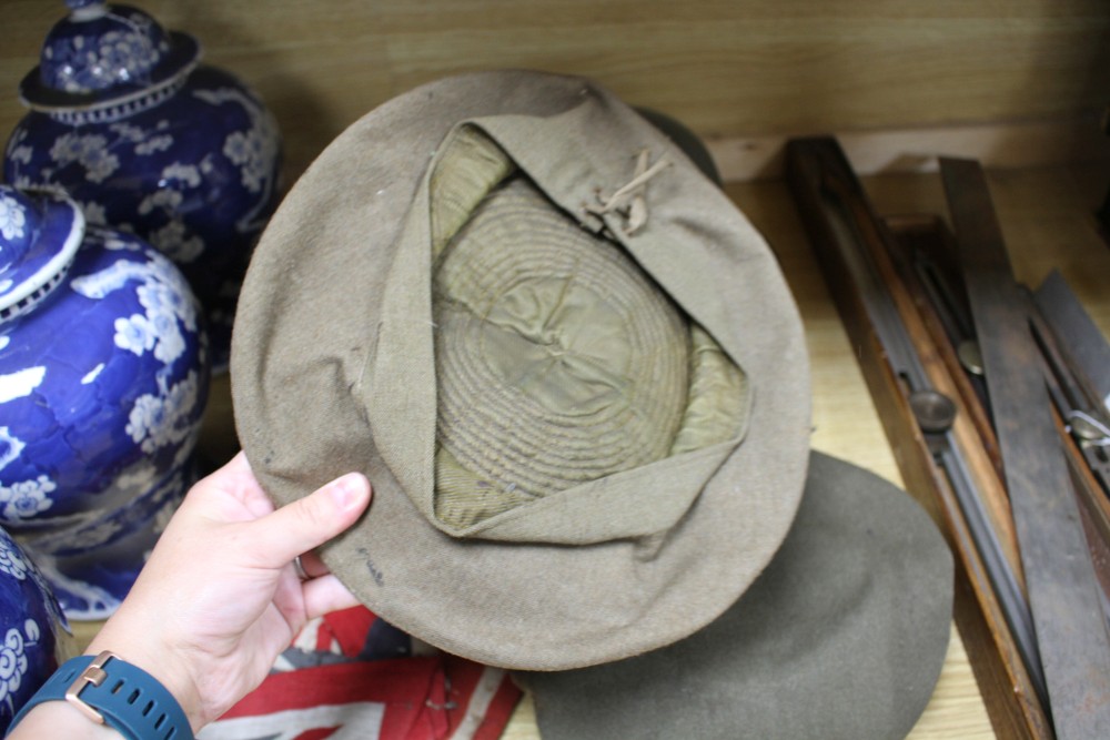 A WWII steel helmet, a Royal Gloucestershire Hussars cap, a Scots Guards? cap, three leather items and a Union Jack